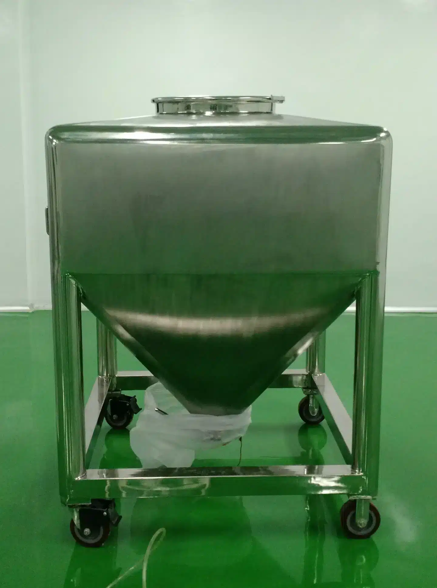 Stainless steel double cone blender mixing equipment in pharmaceutical manufacturing facility