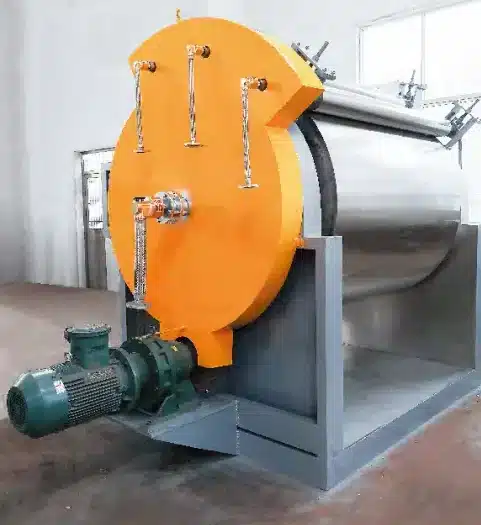 An industrial Vacuum Drum Scraper Dryer featuring a large orange end cap, a cylindrical stainless steel body, motor, and external scraping mechanism, all mounted on a solid grey support frame.